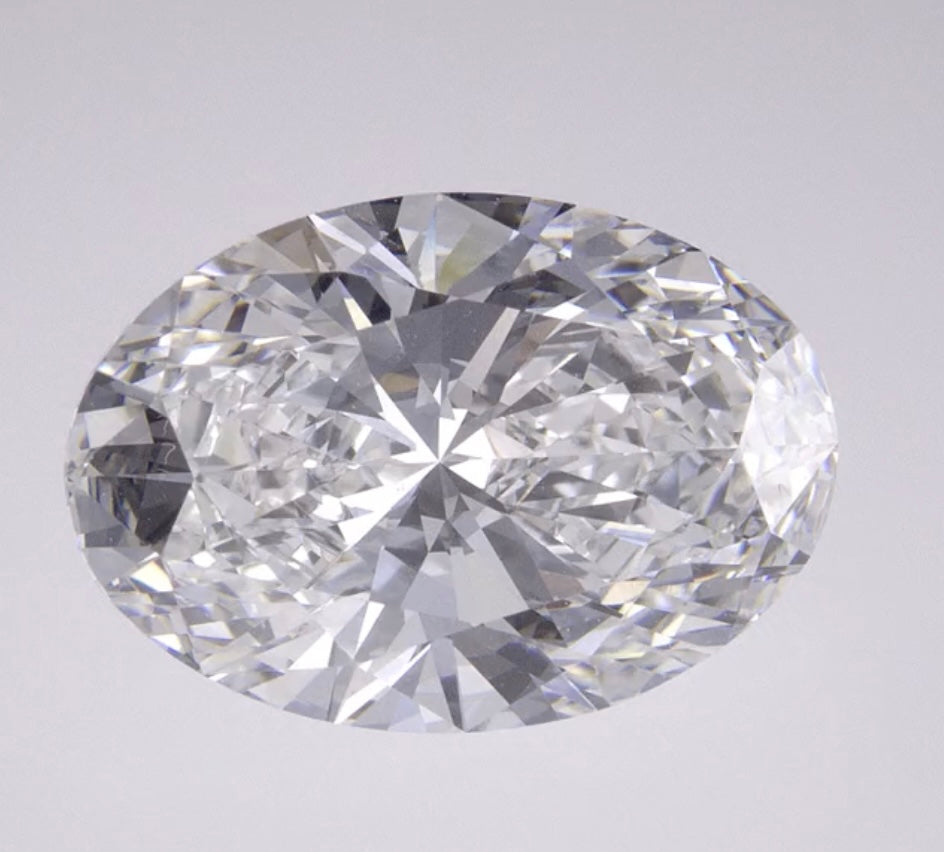 14 karat white gold, thin solitaire bridge mount. Featuring a 5 carat oval Lab grown diamond.