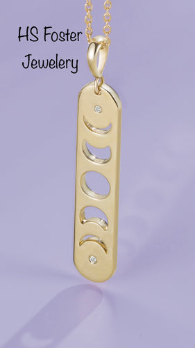 Yellow gold moon phase diamond pendant.