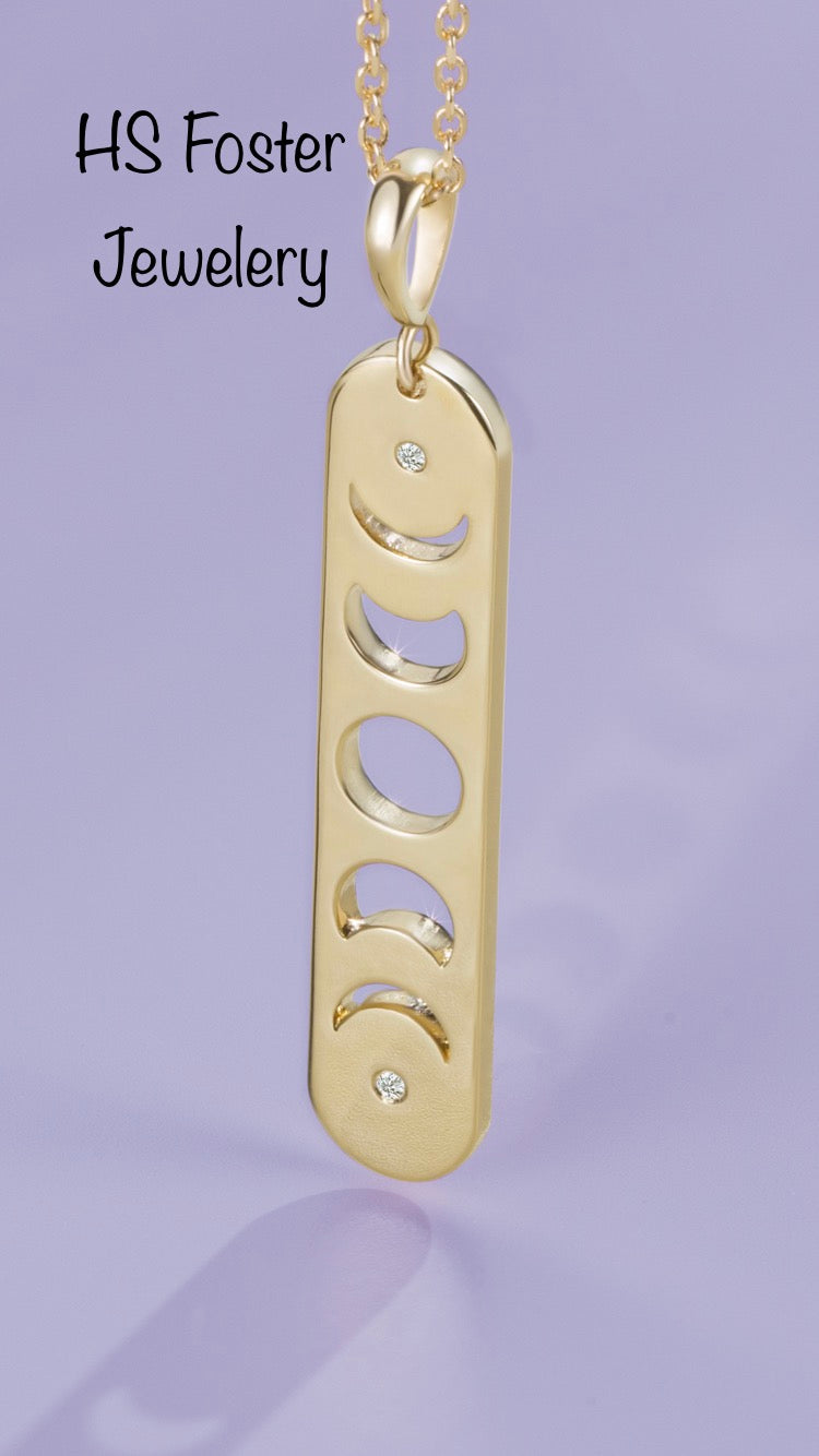 Yellow gold moon phase diamond pendant.